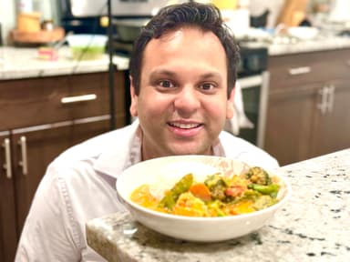 Rohit smiling in his kitchen